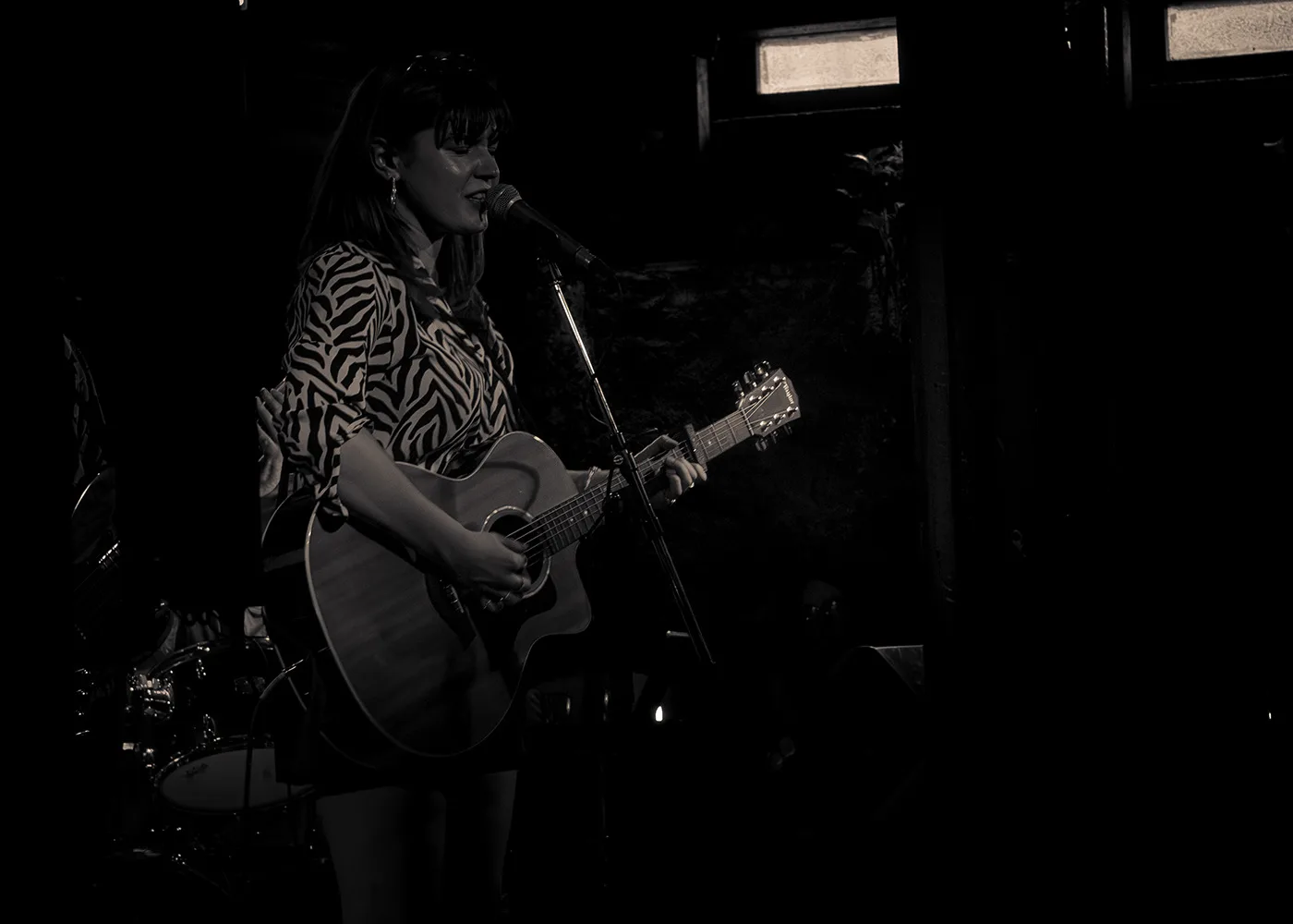 Dani Black playing guitar at Guilt & Co.